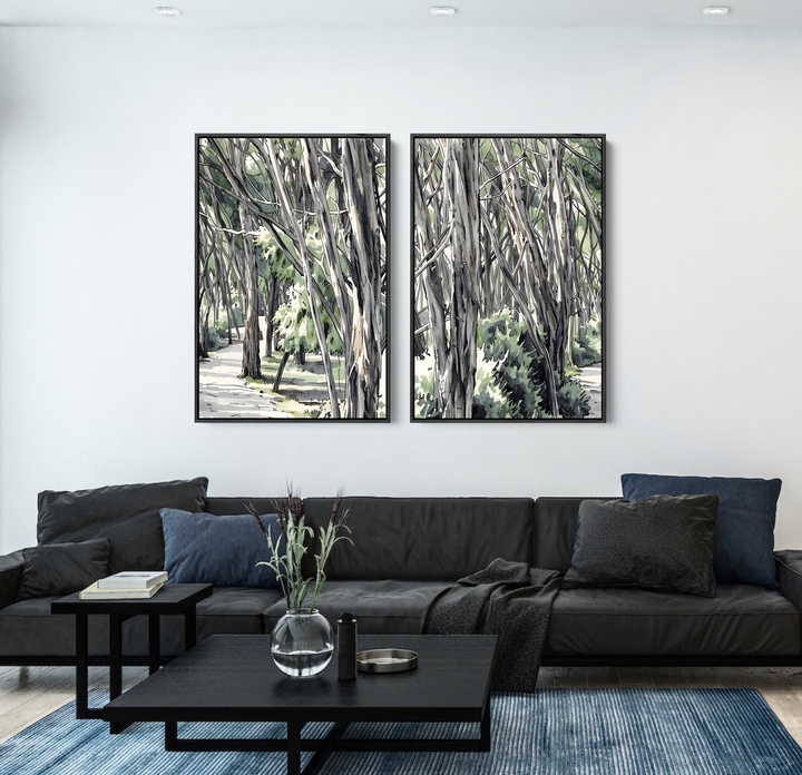 Two framed black and white eucalyptus native botanical forest prints hang above a dark sofa in a living room