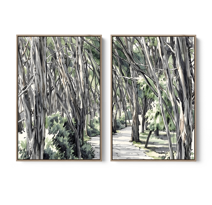 Two framed watercolor paintings of australian eucalyptus forest scenes in gray and green tones with light wood frames