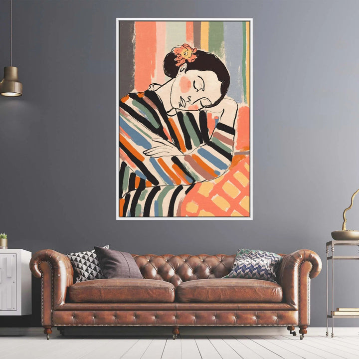 A framed fine art print titled a short nap by treechild featuring a stylized woman in colorful striped attire with an orange flower
