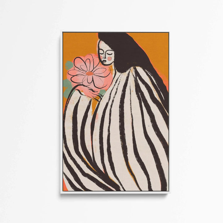 A framed print titled A Silent Moment by Treechild showing a woman in black and white stripes holding a pink flower on orange background
