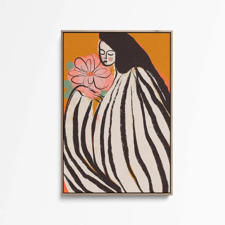 A framed print titled A Silent Moment by Treechild depicting a woman in black and white stripes with a pink flower on orange background
