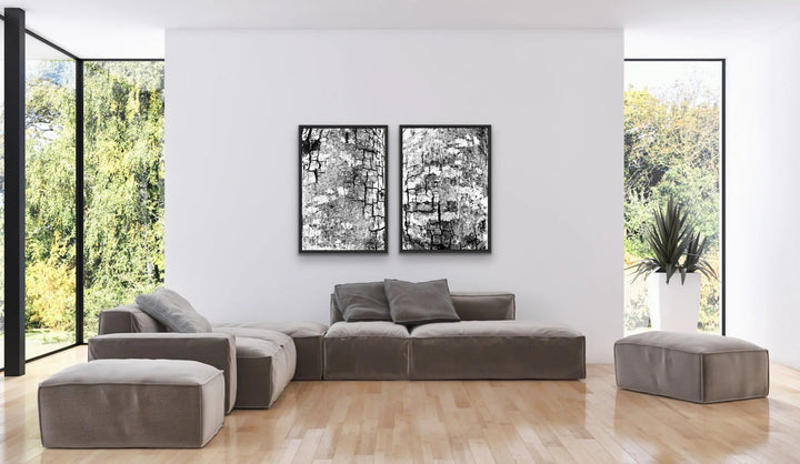 Modern gray velvet sectional sofa with matching ottomans and black and white abstract bark artwork canvas print