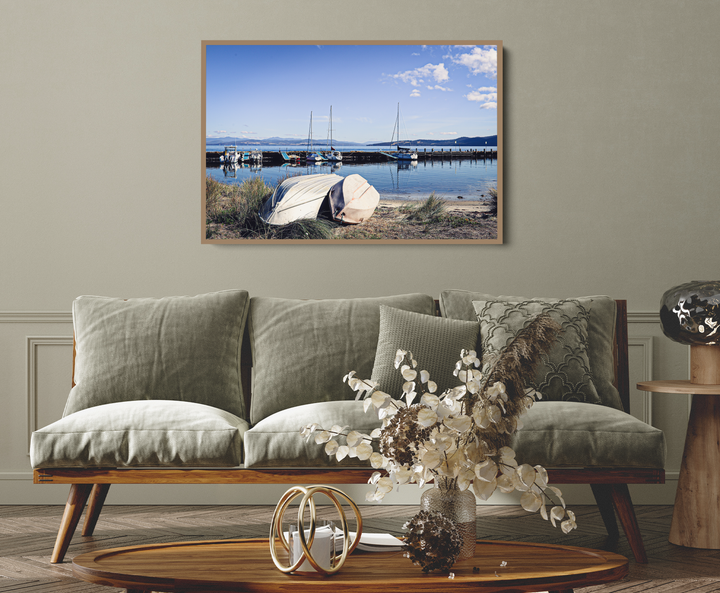 A framed canvas print of a serene harbor scene with sailboats and calm waters at bruny island tasmania by edwina cameron