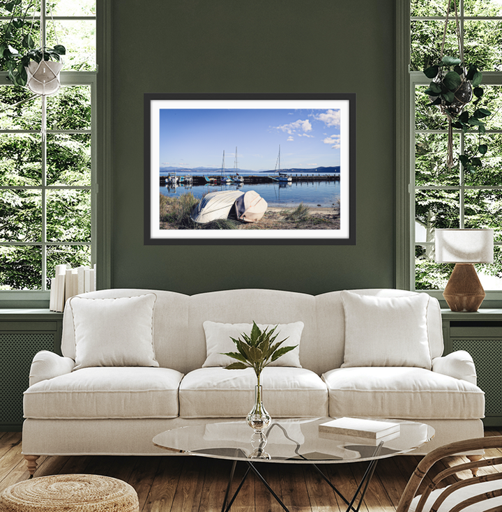 Black-framed rectangular photographic print of a serene harbor scene with white boats and calm blue water at alonnah bruny island tasmania by edwina cameron