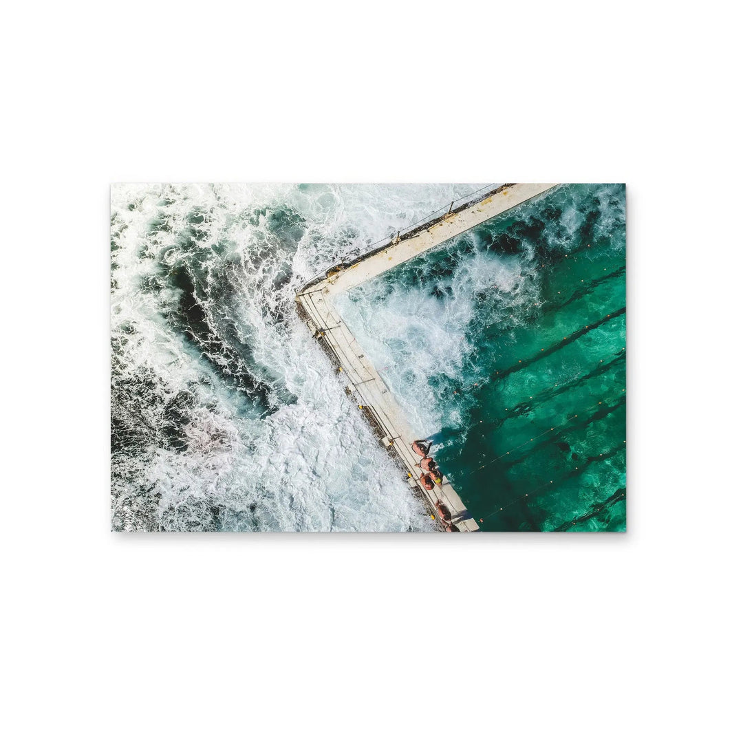 Rectangular photographic stretched canvas print showing vibrant aerial view of ocean waves crashing turquoise pool edge