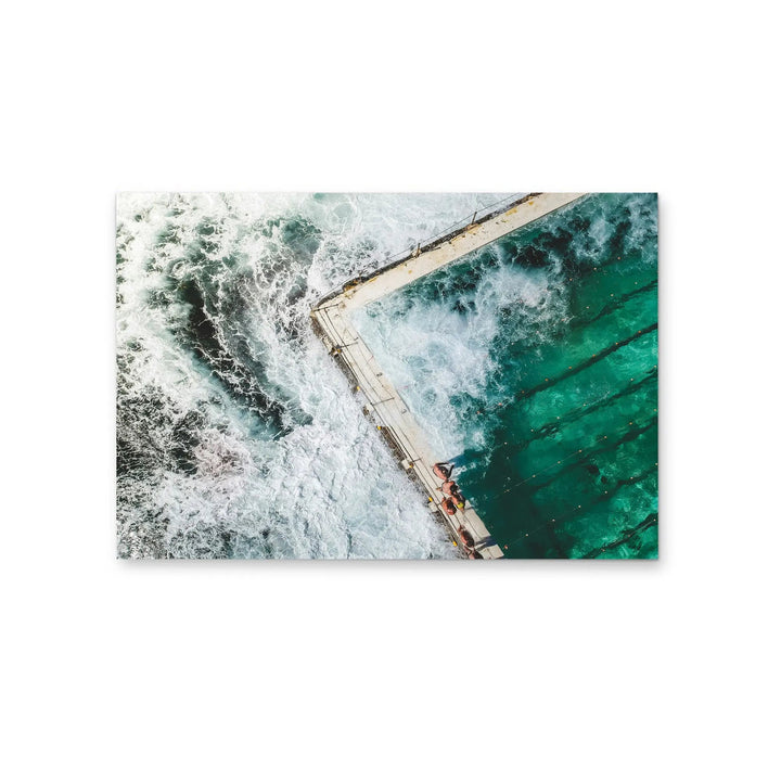 Rectangular photographic stretched canvas print showing vibrant aerial view of ocean waves crashing turquoise pool edge