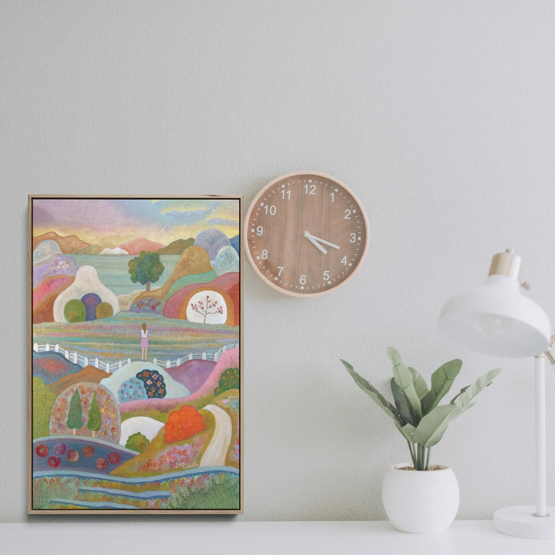 Round wooden wall clock with minimalist design and light brown finish featured in breaking out by angeles m pomata print
