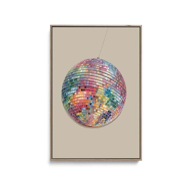 A vibrant multi-colored disco ball with reflective mirror tiles on a stretched canvas print or framed fine art print