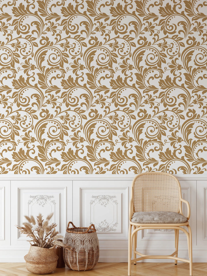 A light beige wicker chair with a woven cane back and seat and gray cushion in a room with doris vintage-inspired wallpaper