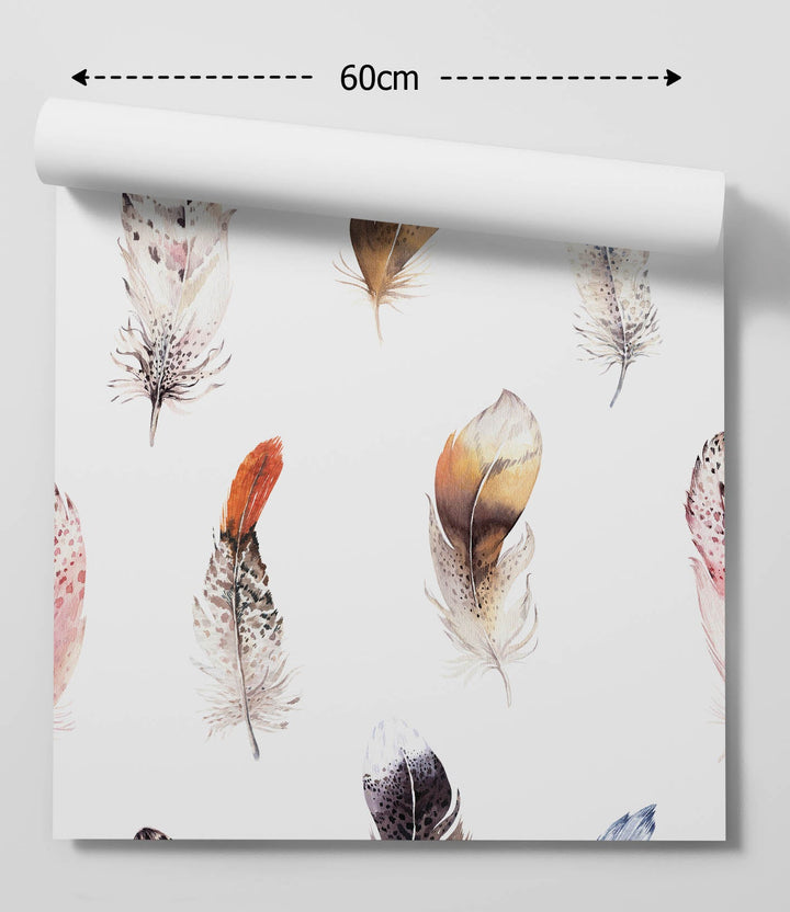 A roll of featherweight white peel and stick wallpaper with delicate watercolor feathers in soft earth tones