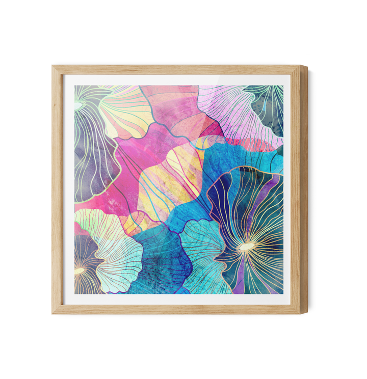 A vibrant pink and blue abstract floral canvas wall art print in a light wood frame with white matting titled glee