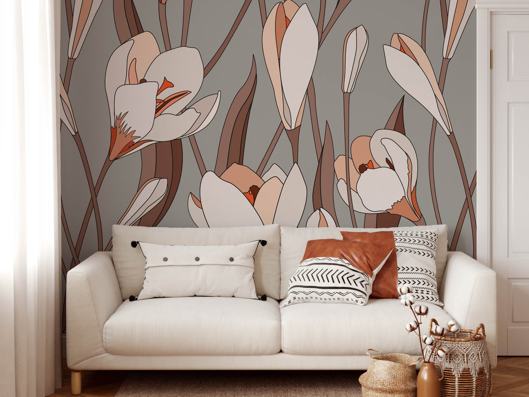 White upholstered sofa with decorative pillows and wooden legs against grey floral grow wild peel and stick wallpaper