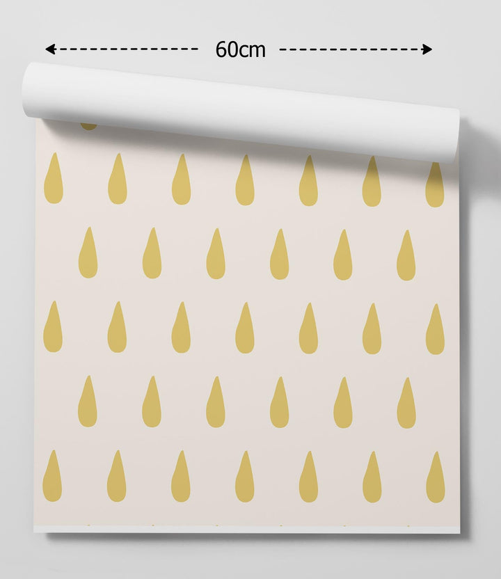 A roll of lemon drop yellow raindrop peel and stick removable wallpaper with golden teardrop pattern on off-white background