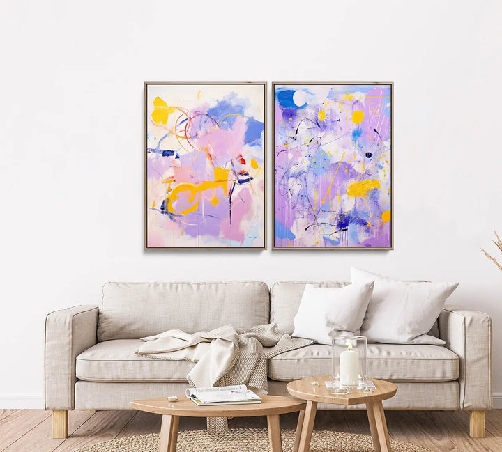 Two framed abstract paintings with vibrant purple pink yellow and blue splashes in lilac dreams print set