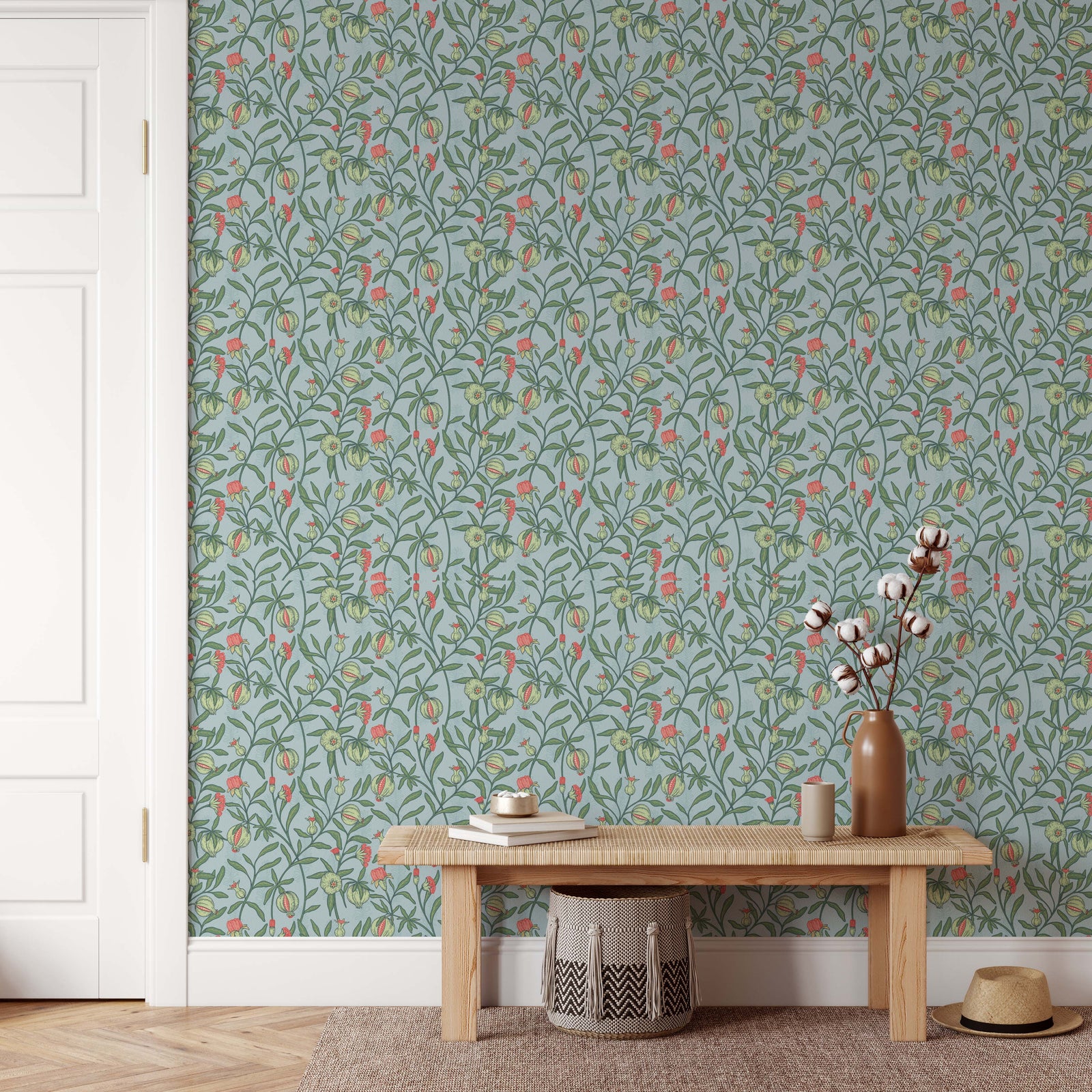 A tall matte brown ceramic vase holding cotton stems featured on little bud vintage floral peel and stick wallpaper