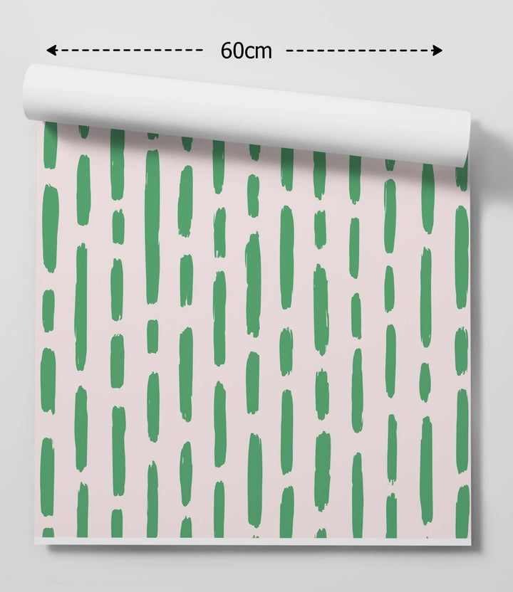 Roll of minty fresh green stripe peel and stick removable wallpaper with vertical green brushstrokes on soft pink background