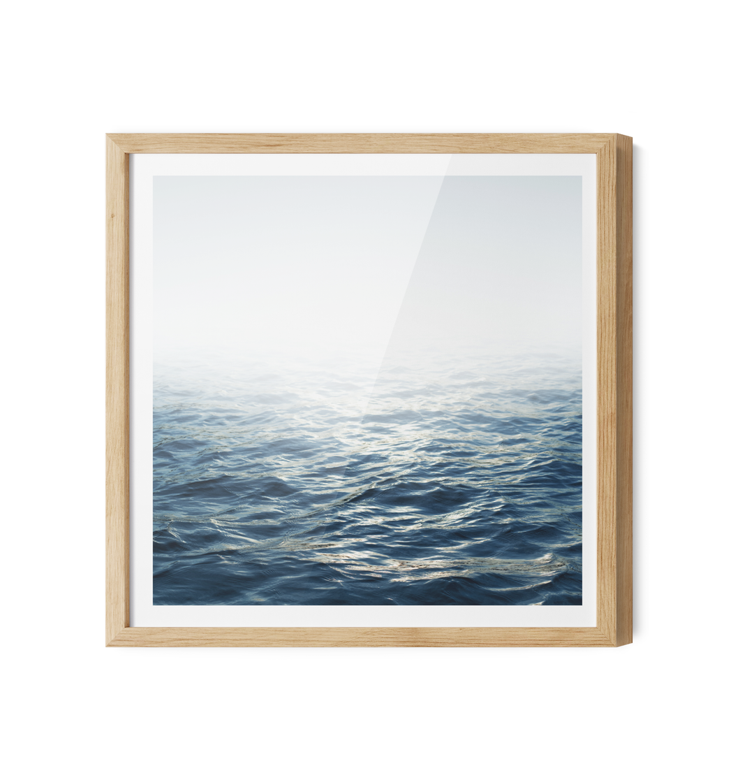 Moonlit ocean hamptons water coastal print on canvas with deep blue waves and white mist in light wood frame