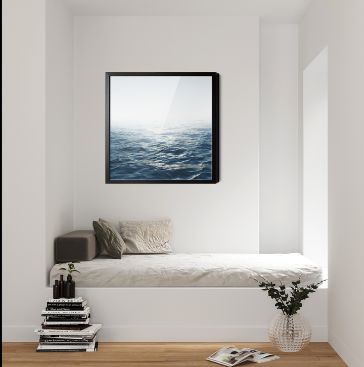 Black-framed canvas print of a textured blue ocean under a soft white sky titled moonlit ocean hamptons water coastal print