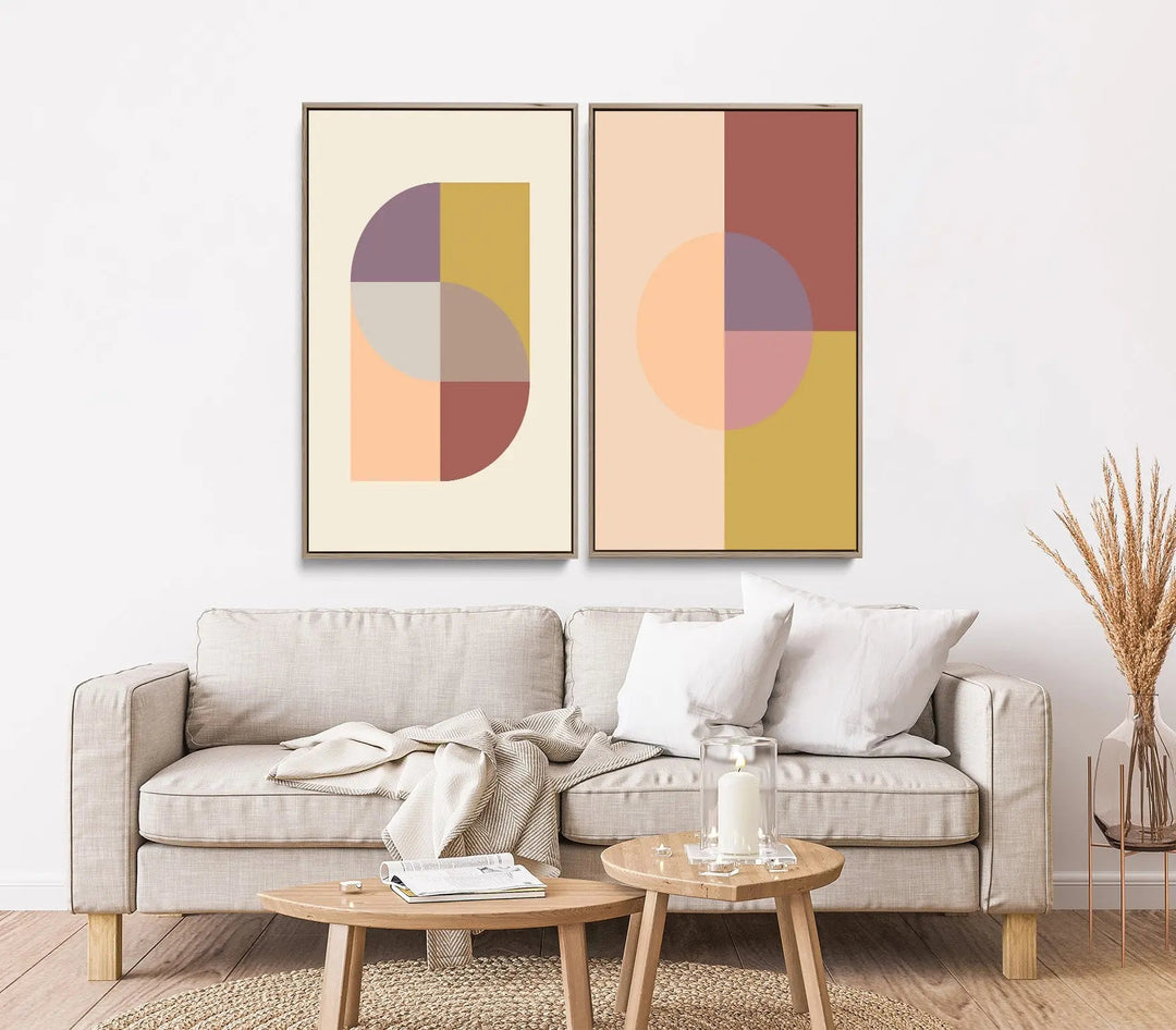 Two piece geometric print set featuring abstract art in muted earth tones framed above a beige sofa