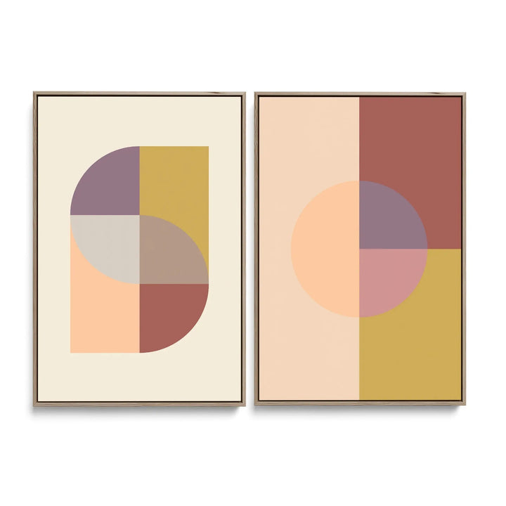 Two minimalist abstract art prints in gold frames featuring soft earth-toned geometric shapes on cream background