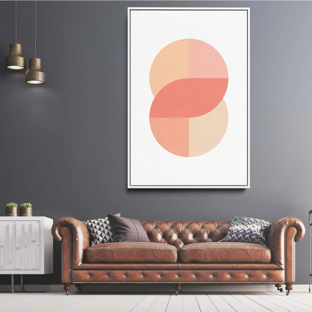 Brown leather tufted chesterfield sofa with rolled arms and nailhead trim shown alongside peach 41 pastel geometric art print
