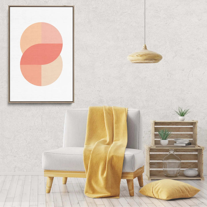 White armchair with light wood legs draped in mustard yellow throw next to peach 41 pastel geometric canvas print