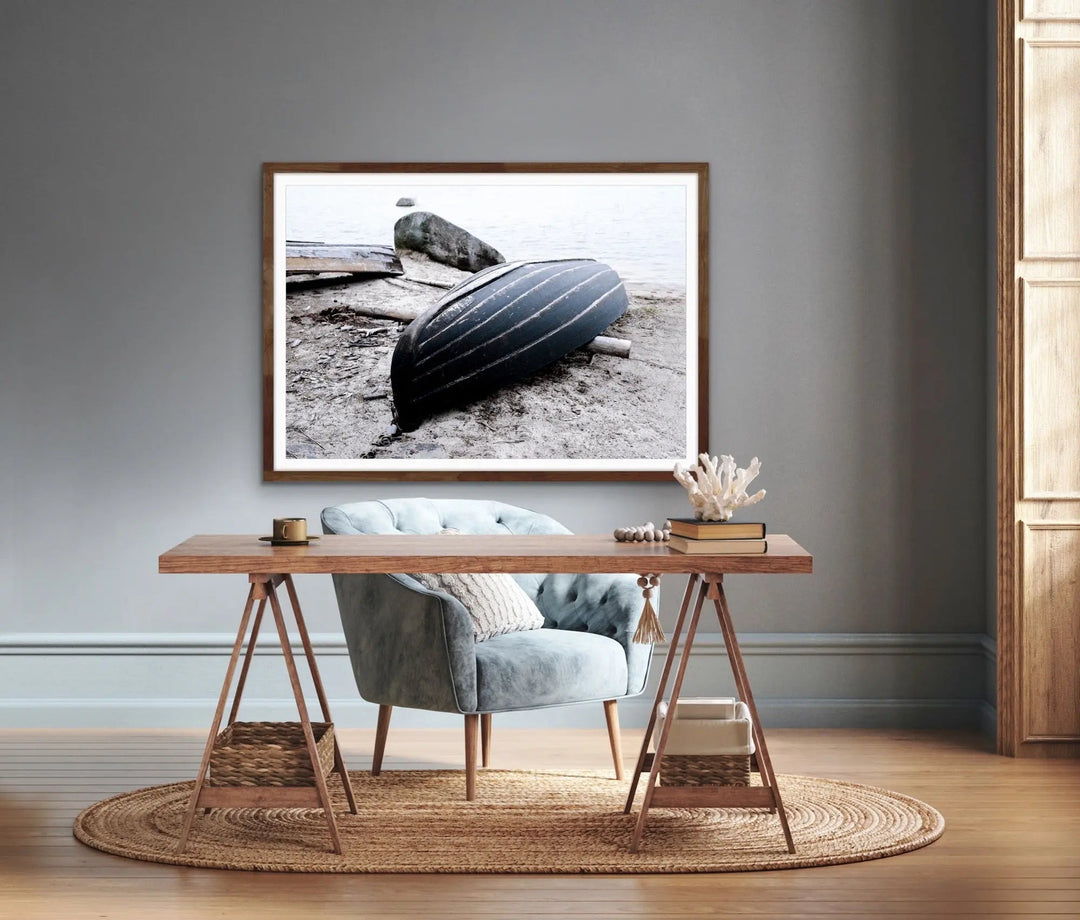 Rowboat on the shore stretched canvas photographic print featuring a black striped rowboat in a wooden frame
