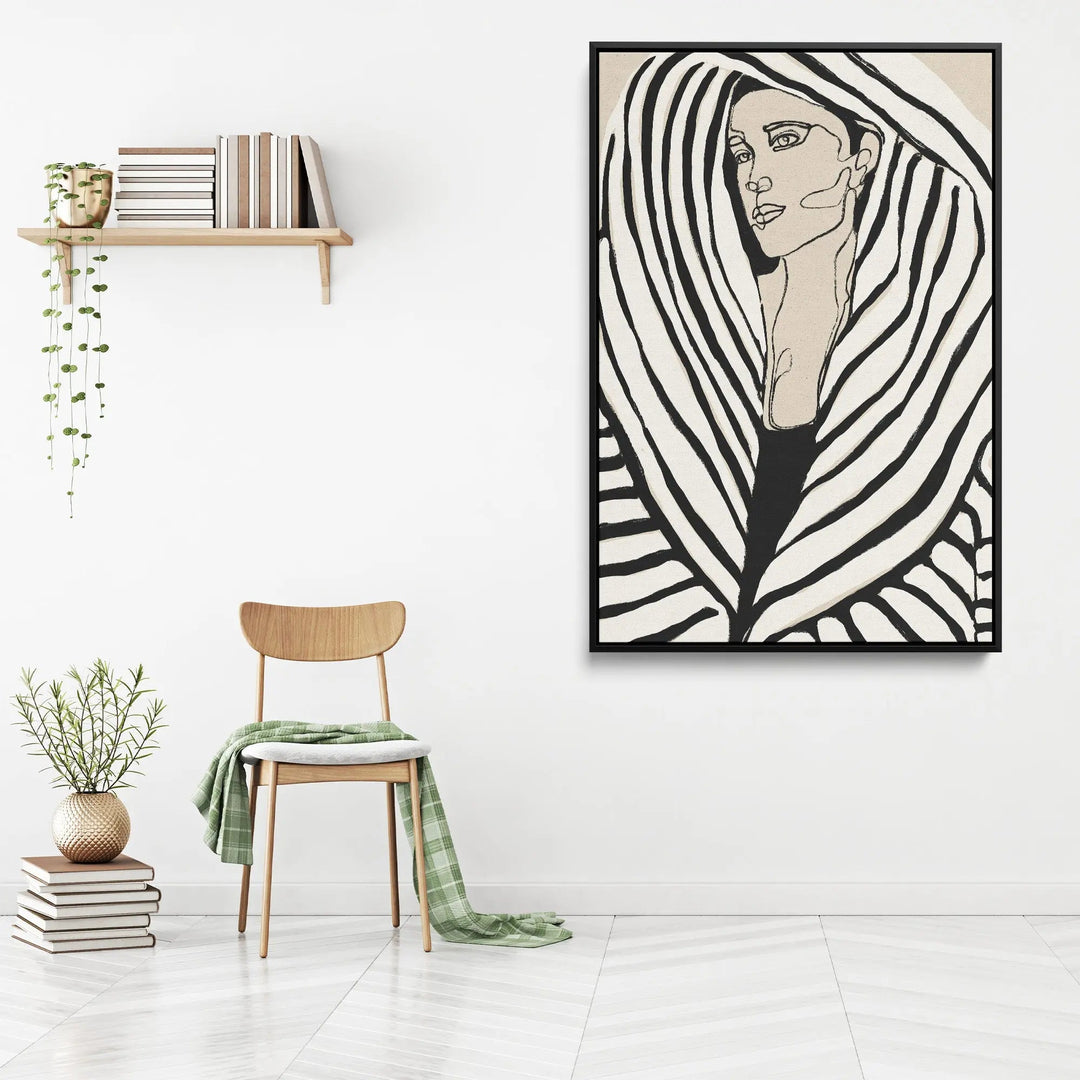 Black-framed stretched canvas print of a woman with bold black and white stripes on beige background by Treechild
