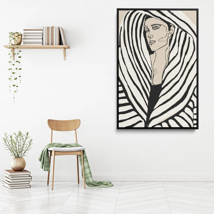 Black-framed stretched canvas print of a woman with bold black and white stripes on beige background by Treechild