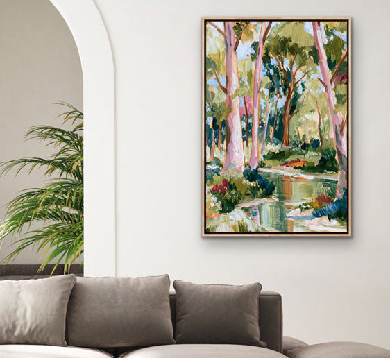 Modern living room with a large sectional sofa, round coffee table, and a painting of a garden on the wall.