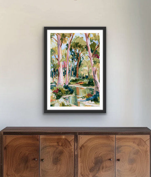 Foyer with a chandelier, wooden sideboard, and framed artwork on a white wall.