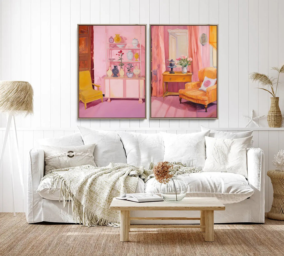Two framed pastel pink and yellow interior prints hang above a white sofa in this home of ours print set