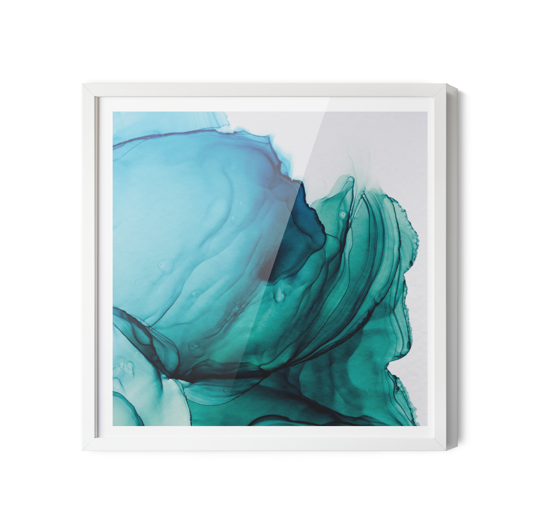 A framed abstract alcohol ink wall art print featuring swirling teal and blue patterns in a white frame