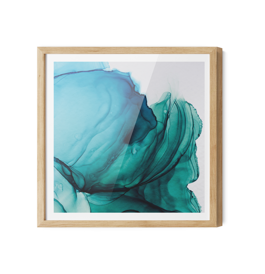 Unwind blue and green abstract alcohol ink wall art print with flowing teal and blue inkblot patterns in light wood frame