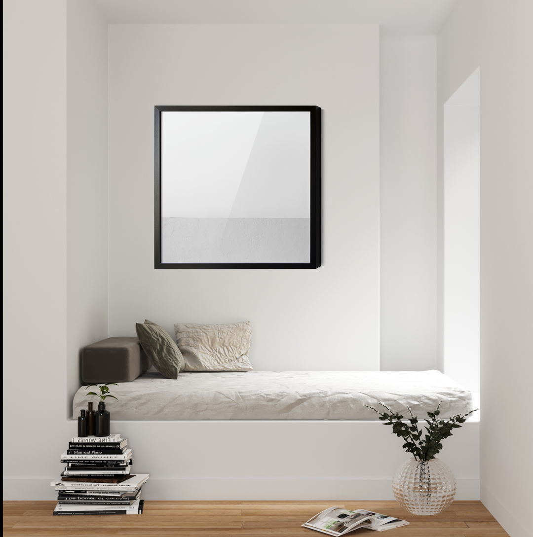 Black-framed square mirror hanging on a white wall complementing white whispers square abstract white grey geometric wall art canvas print