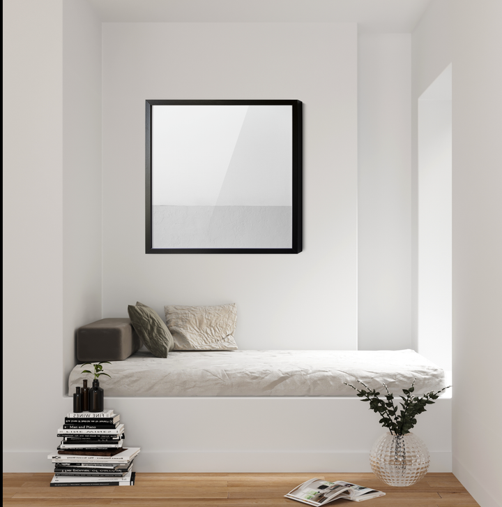 Black-framed square mirror hanging on a white wall complementing white whispers square abstract white grey geometric wall art canvas print