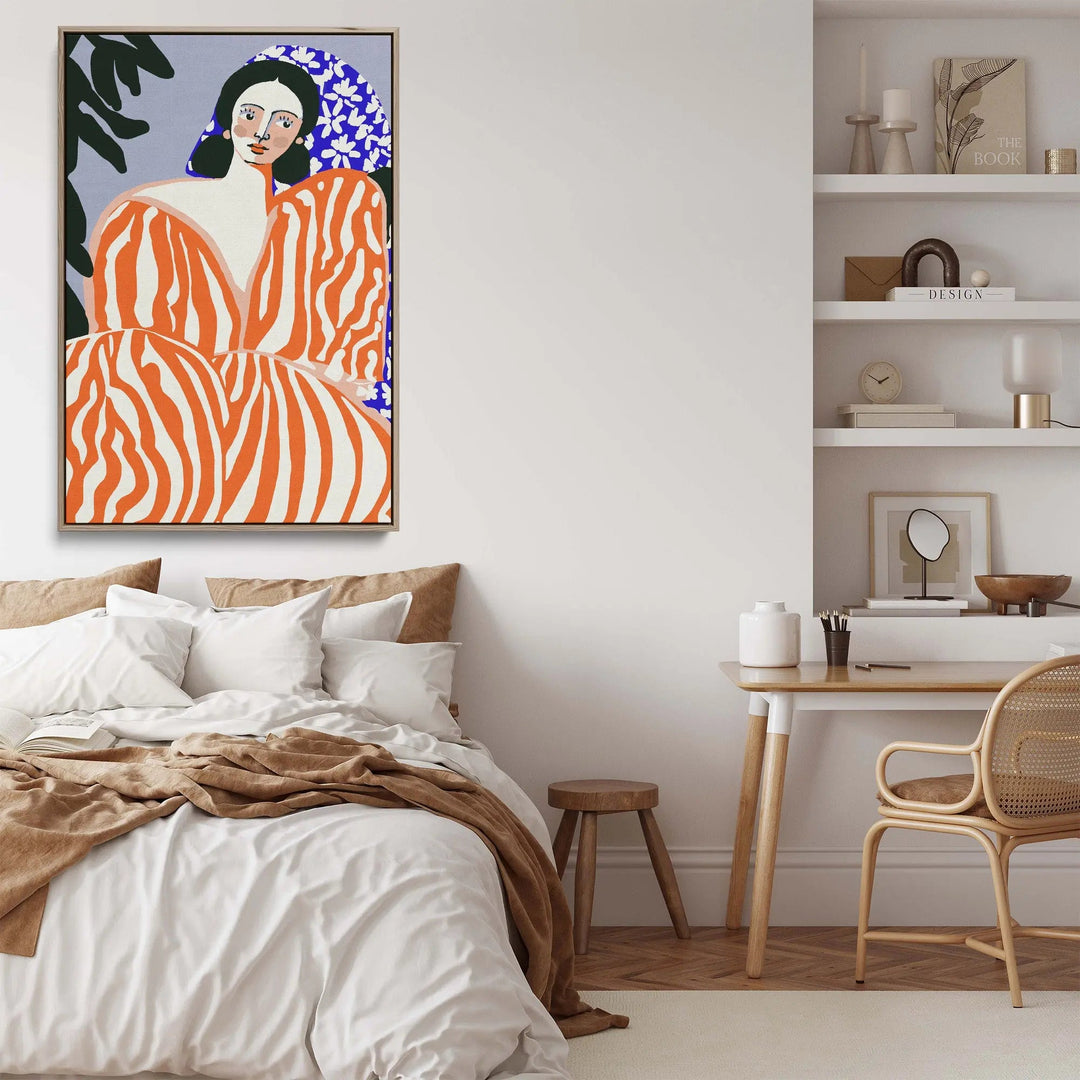 Vibrant orange and white zebra-striped canvas art by Bea Muller featuring a stylized woman with dark hair and blue floral background framed in silver