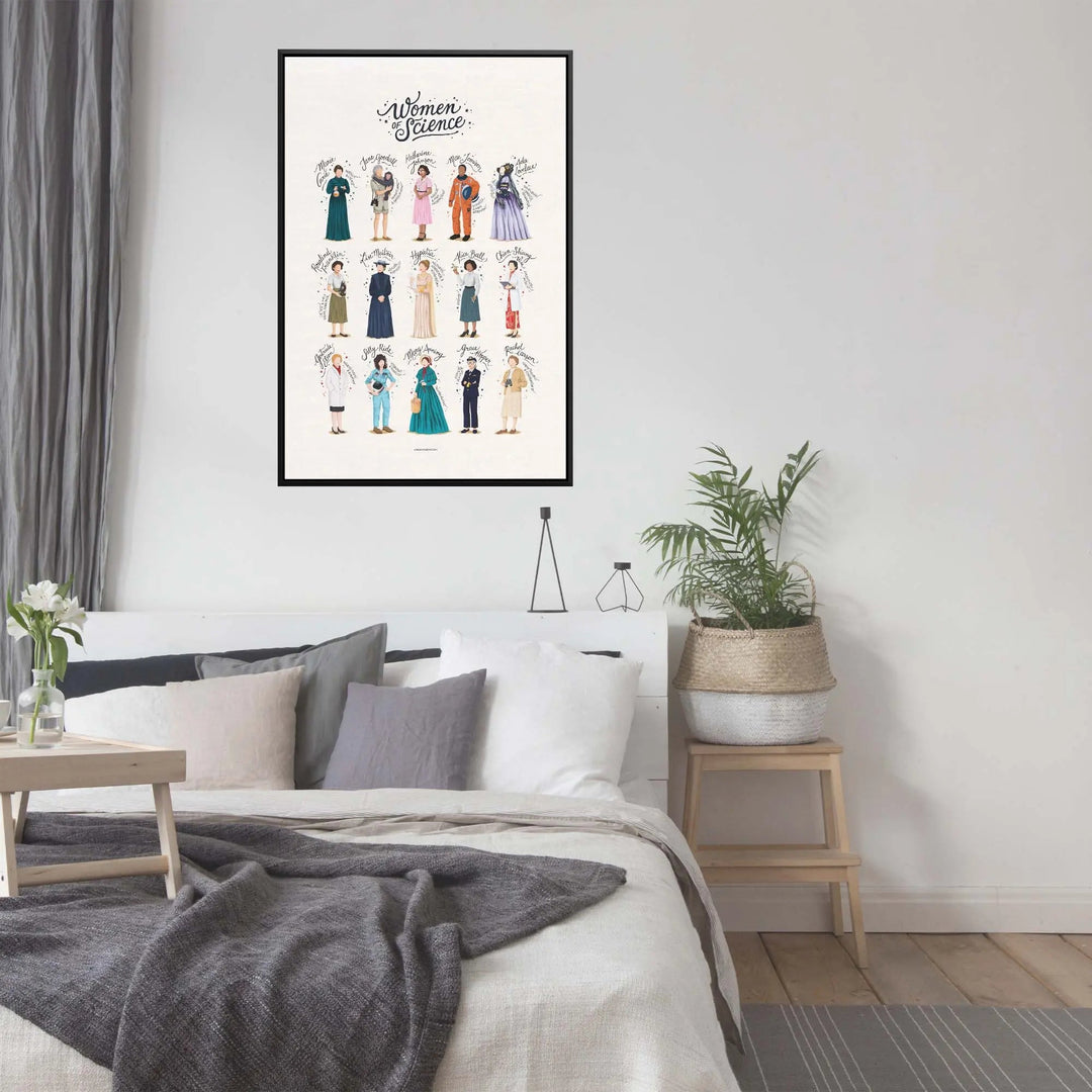 A framed women of science poster by Nour Tohme with colorful illustrated scientists displayed above a bed